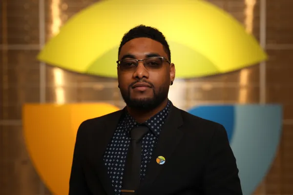 a man wearing glasses and a suit