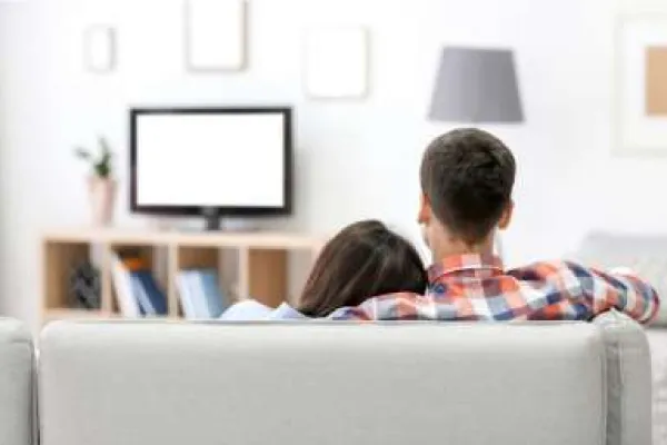 couple sitting on couch watching television