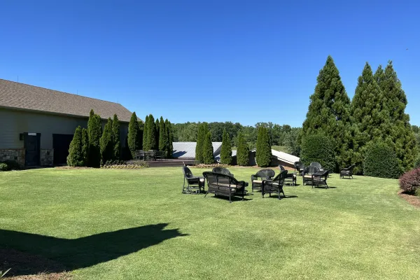 a lawn with chairs and tables