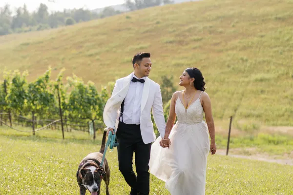 a man and woman walking a dog