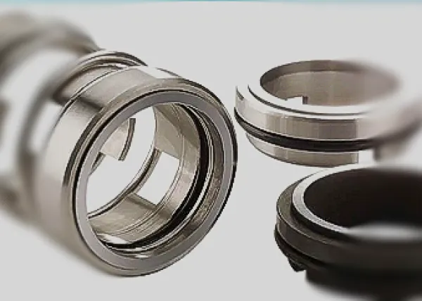 Close-up of mechanical seal components including metal casing and rubber rings on white background.