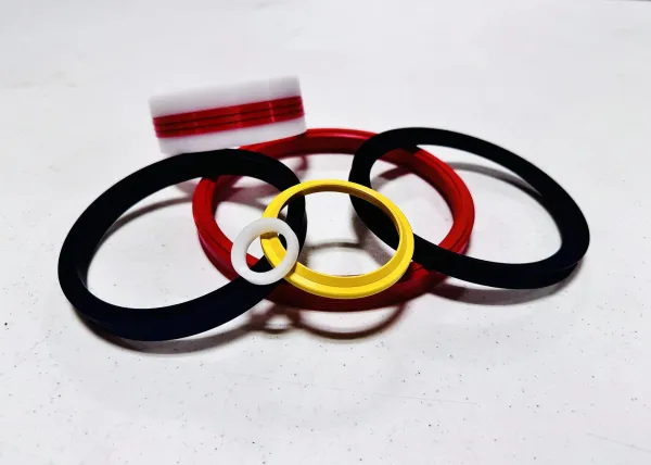 Various colored plastic rings arranged on a white surface casting shadows.