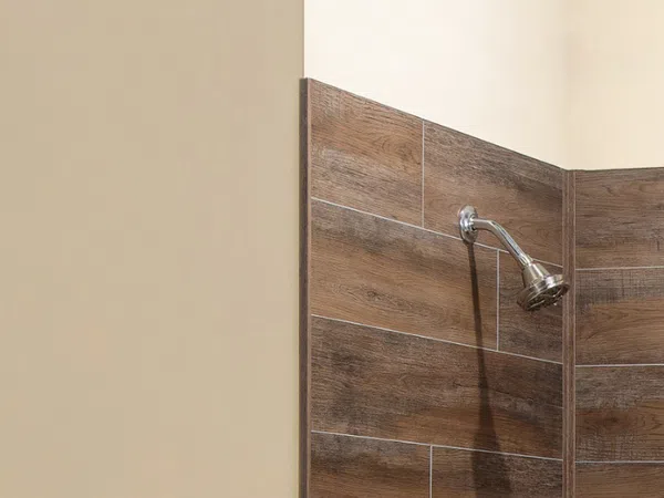 Modern shower area with wood-look wall tiles and a chrome showerhead in a neutral bathroom corner.