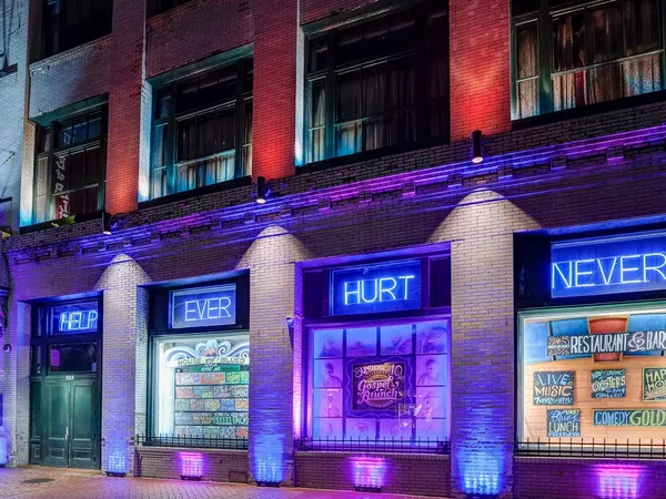 House of Blues building lit with purple and blue lights with overlaid text reading HELP EVER HURT NEVER
