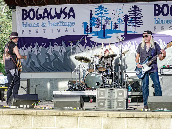 Live blues band performing on stage at the Bogalusa Blues and Heritage Festival outdoor event.