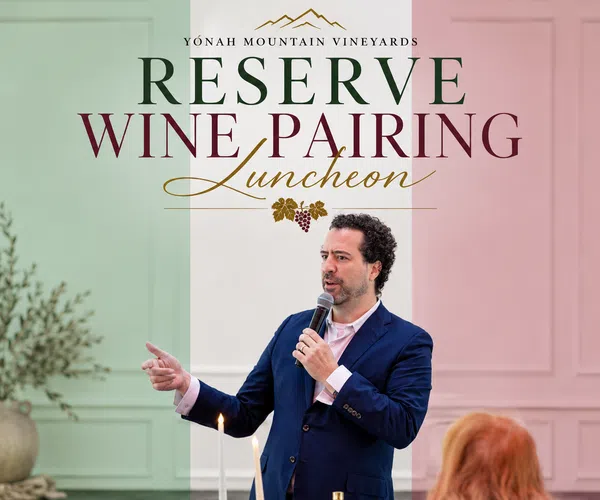 Man in navy suit speaking at Yonah Mountain Vineyards Reserve Wine Pairing Luncheon event.