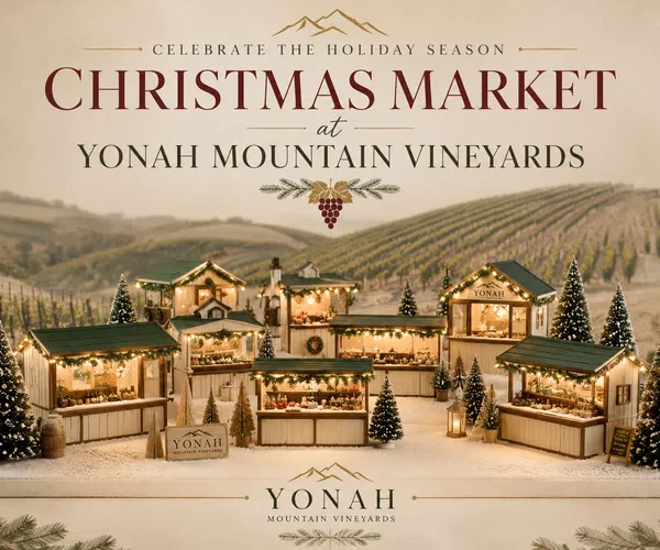 Christmas Market at Yonah Mountain Vineyards with festive market stalls and snow-covered pine trees.
