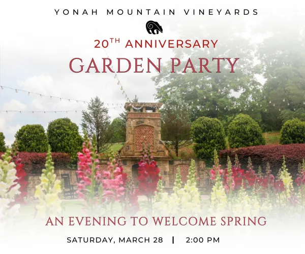 Garden with colorful flowers and stone fireplace for Yonah Mountain Vineyards 20th anniversary garden party event.