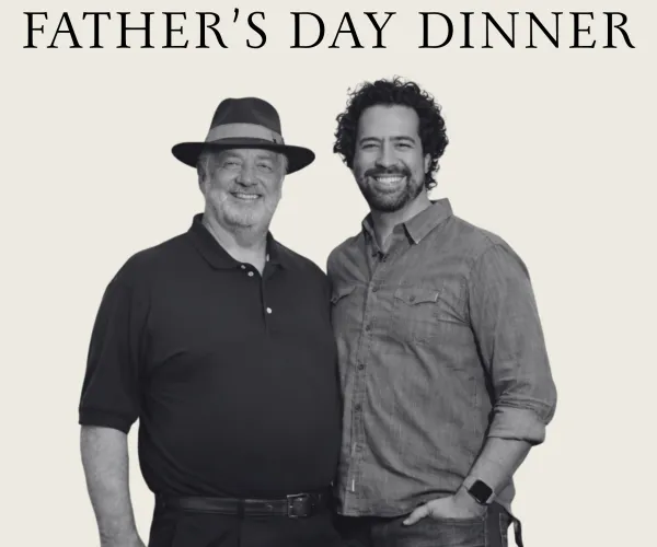 Father and son smiling for Yonah Mountain Vineyards Father's Day Dinner event on June 20 at 6:30 PM.