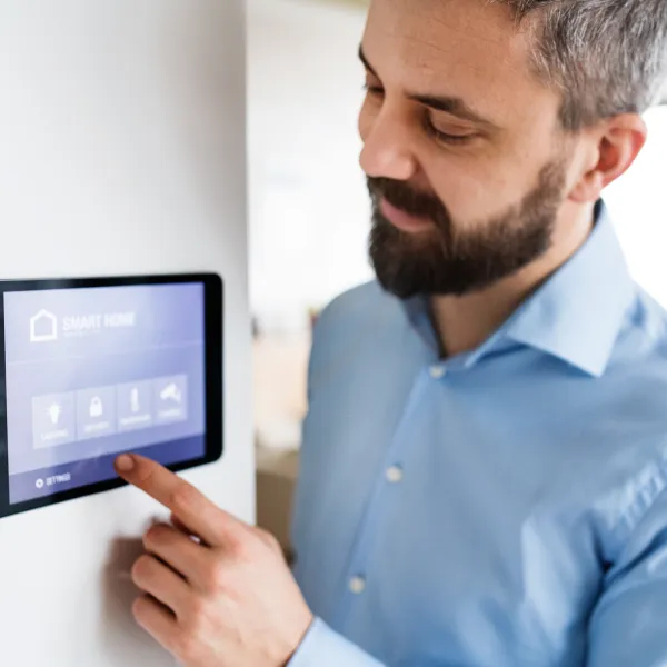 a man adjusting thermostat