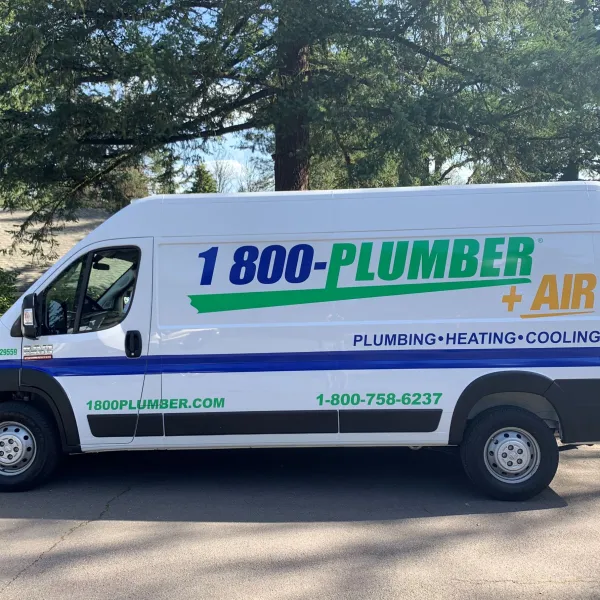 a green and white van parked in front of a truck