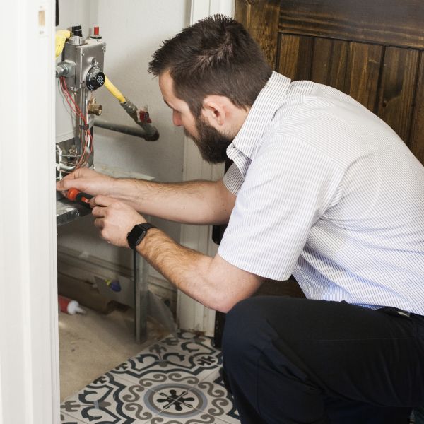 a man sitting in front of a refrigerator