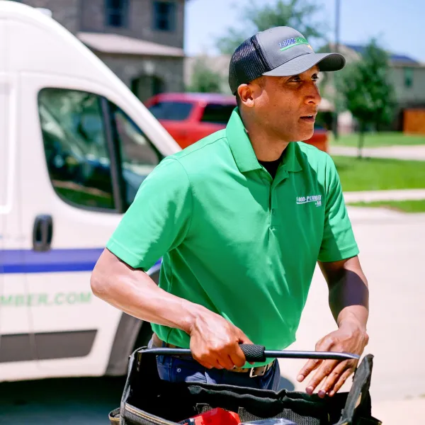 a technician wearing a green shirt in front of a van
