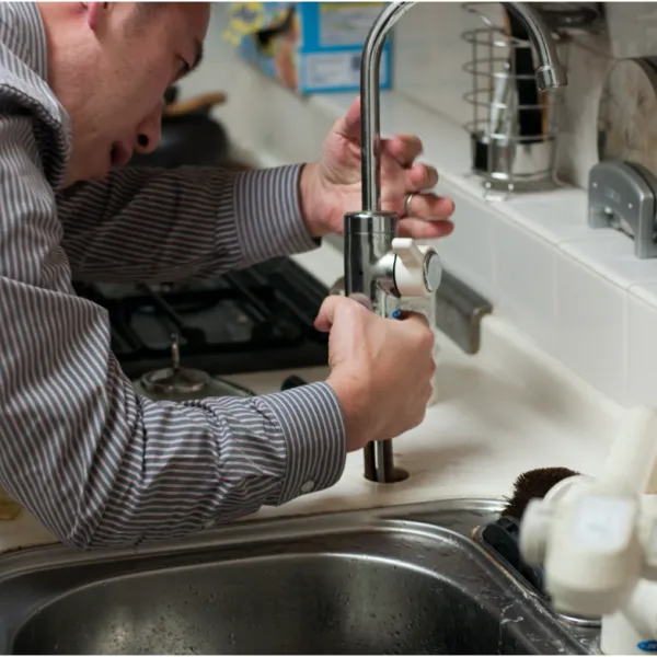 a man drinking from a sink