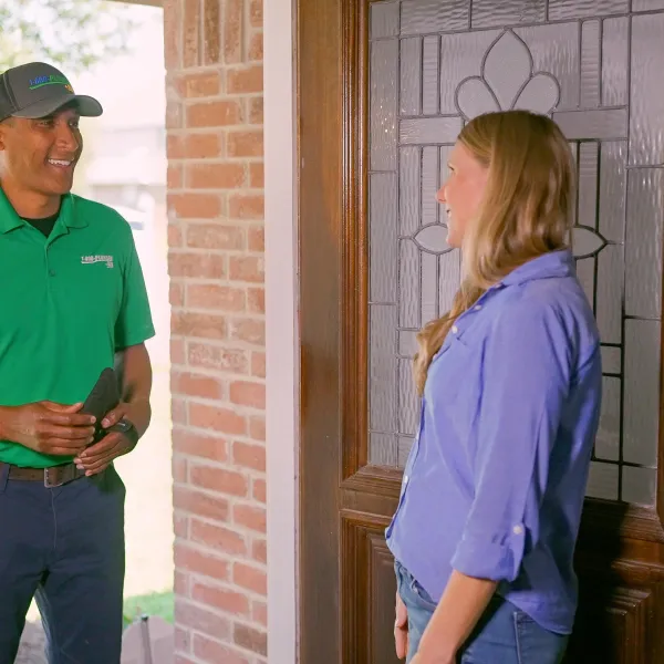 A Scottsdale thermostat technician greets a homeowner
