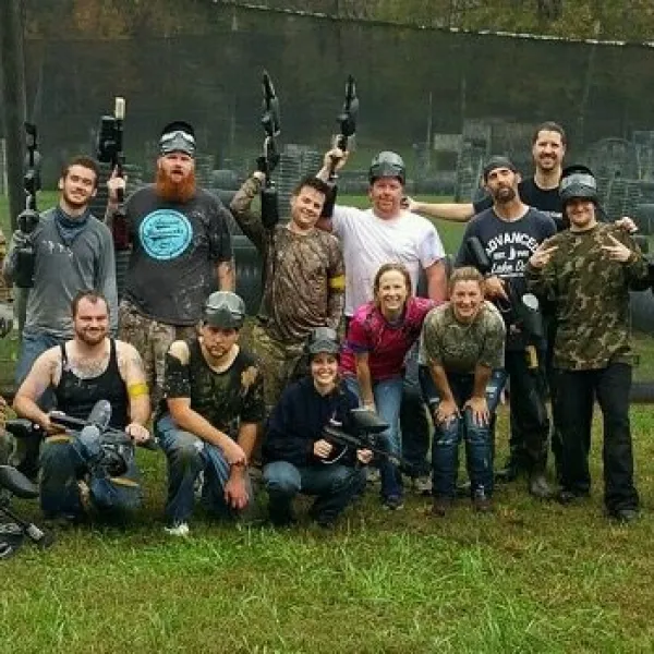 a group of people posing for a photo with paintball guns