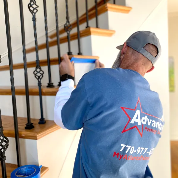 a man painting a staircase