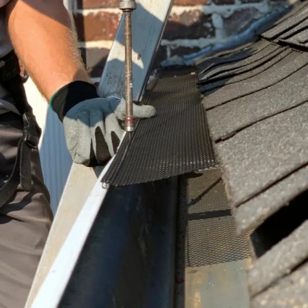 a person holding a gutter cover