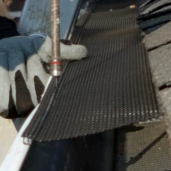 a person installing a gutter cover