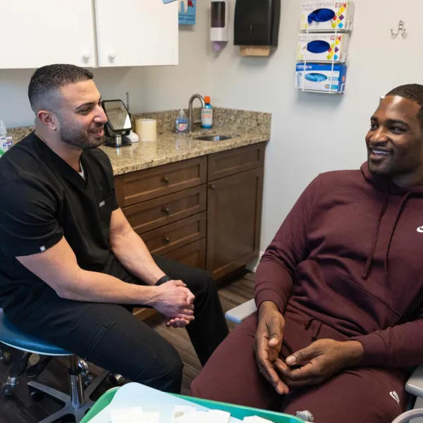 Healthcare professional talking with patient in a modern medical office during consultation.