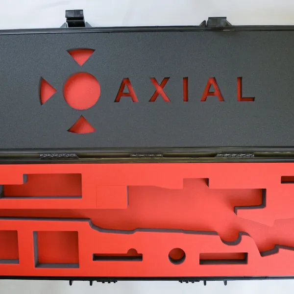 Black gun case with red foam interior cutouts and AXIAL logo on the lid, designed for firearm storage.