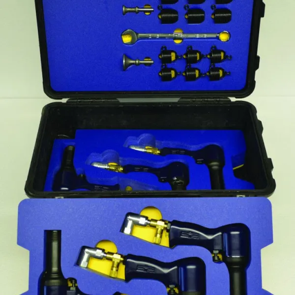 Black and gold industrial nozzles and components organized in blue foam inside a hard case.