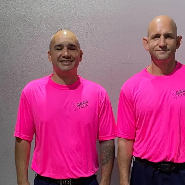 two men in pink shirts