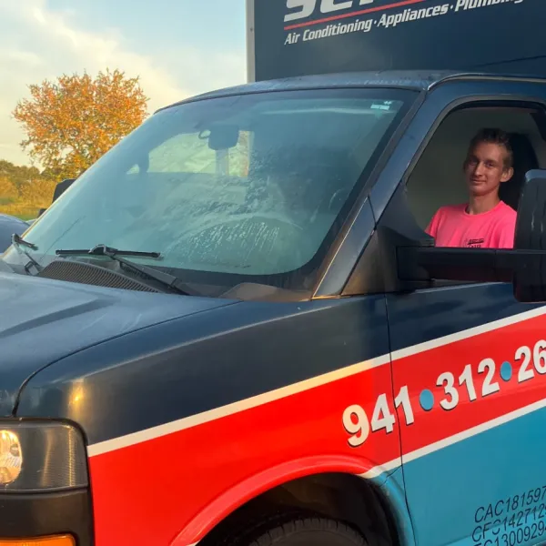 a person driving a red and white truck