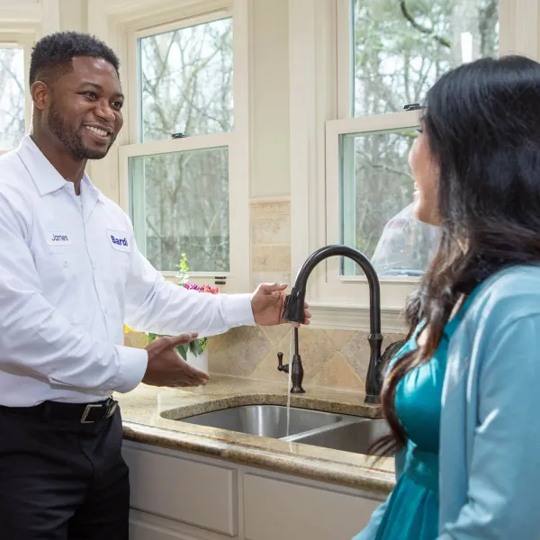 a man and a woman standing in a kitchen