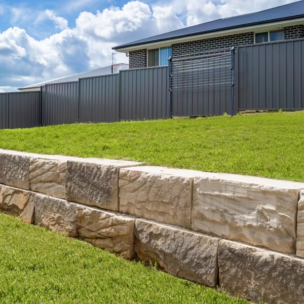 a stone wall in front of a building