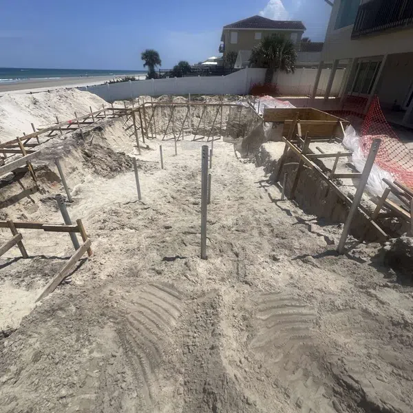Helical pile installation for a pool excavation near beachfront home