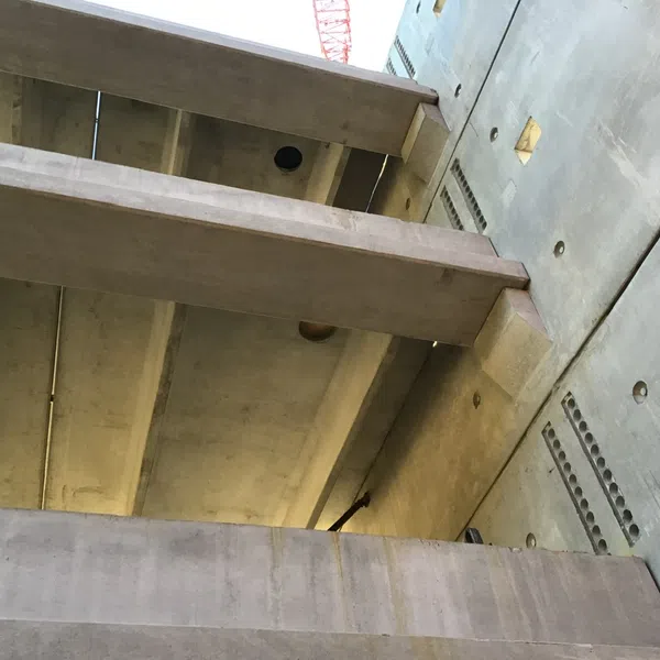Close-up of a concrete structure with beams and walls under construction showing industrial architectural details
