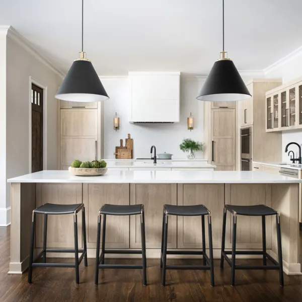 Modern kitchen with a large island, stylish black pendant lights, and sleek wooden cabinetry.