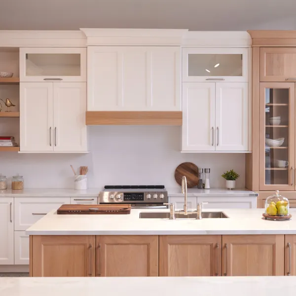 a kitchen with creme cabinets