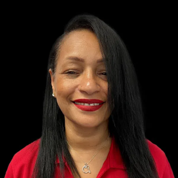 Smiling woman with long black hair wearing red polo shirt with a logo and red lipstick on black background