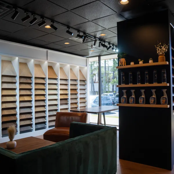 Modern showroom with wood samples on display, lounge seating, and large windows letting in natural light