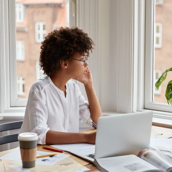 a person sitting at a table with a laptop