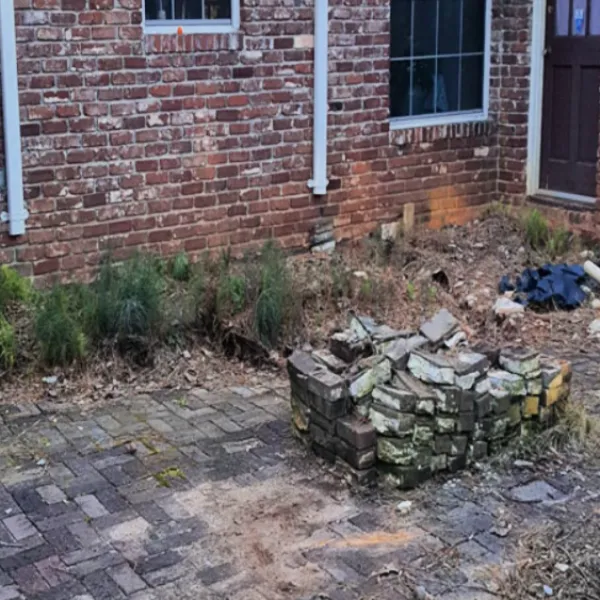 a pile of rubble next to a brick building