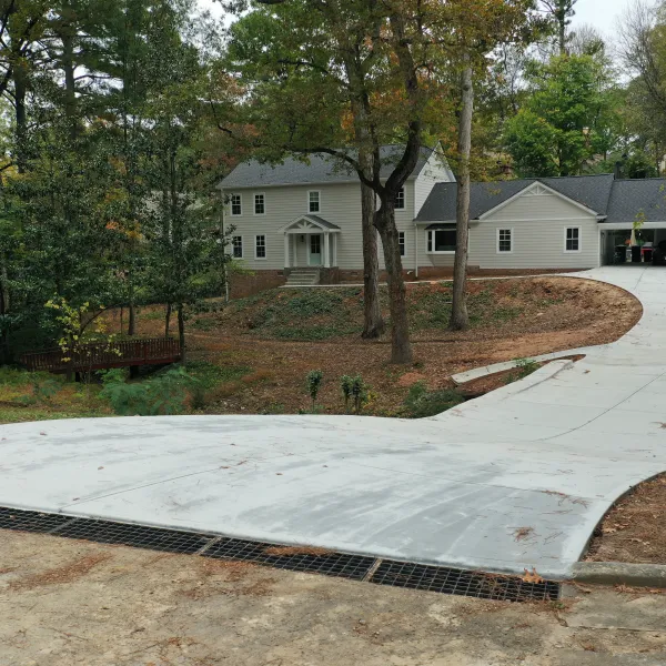 a house with a driveway and trees