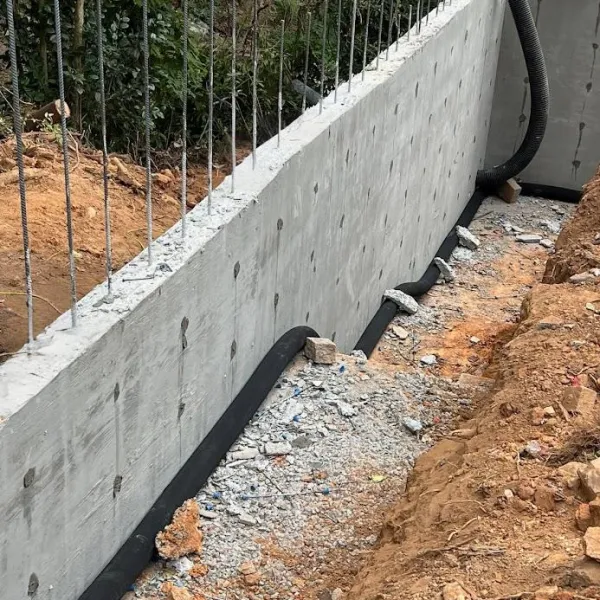 a concrete wall with a fence