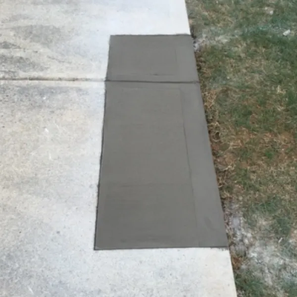 a grey rectangular object on a concrete surface