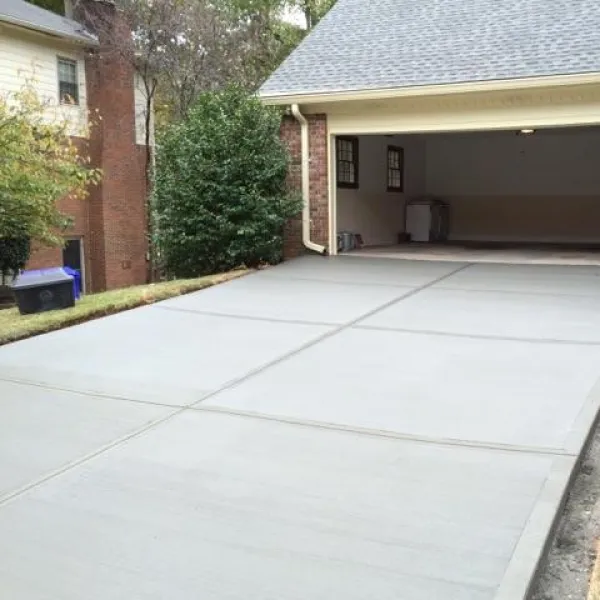 a driveway with a garage and a house