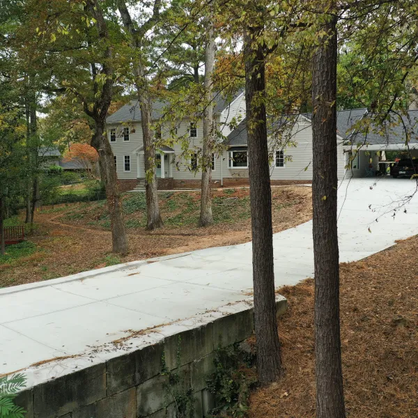 a road with trees and a building in the background