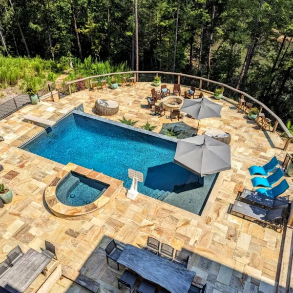 a pool with a deck and chairs