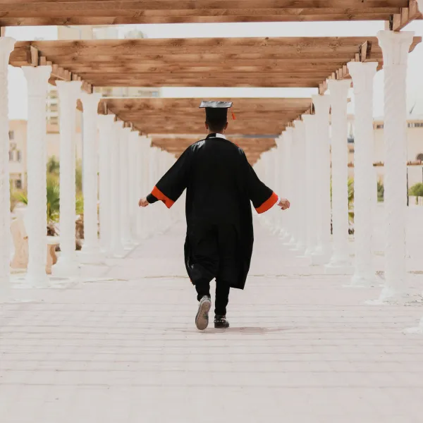 a man in a graduation gown walking