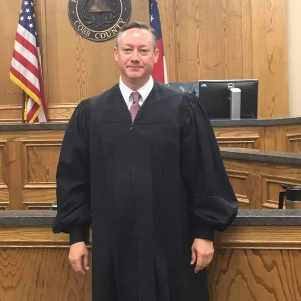 a man in a suit standing in front of a podium