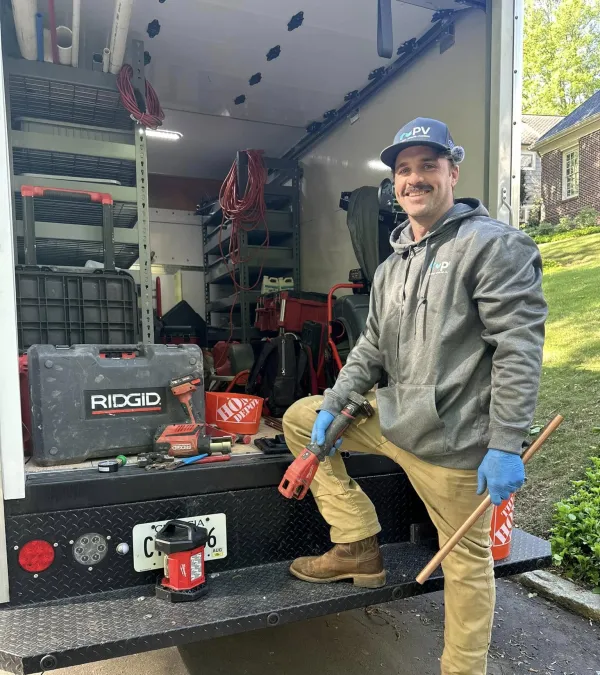 A skilled worker in a truck surrounded by tools, showcasing a professional setup for plumbing tasks.