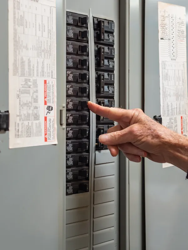 a hand pointing to a computer