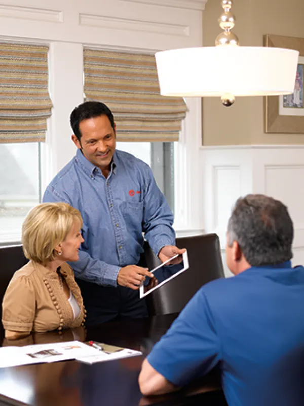 a man and a woman talking to a man at a table