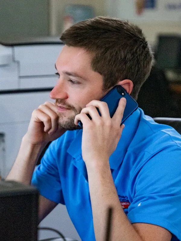 a person sitting in a chair talking on a cell phone